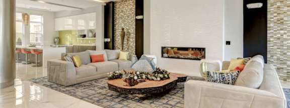 a living room with two couches and a coffee table in front of a fireplace at Ascend Apollo Apartments, Largo, MD, 20774