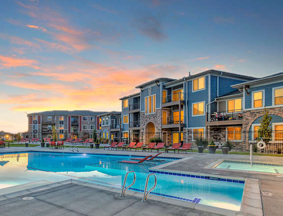 A large swimming pool surrounded by apartment buildings.