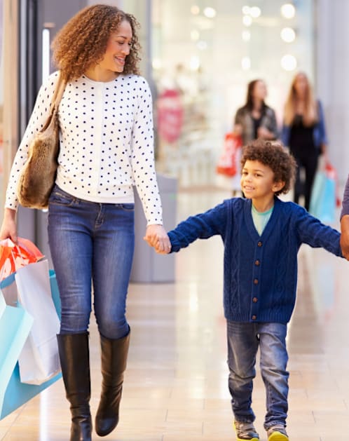 Family of three is walking hand in hand in a shopping mall at Rivers at Bluegrass, Kentucky, 40503