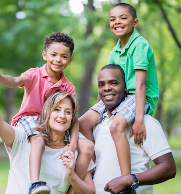 A family of four is enjoying a day out in the park.