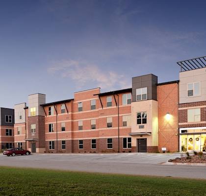 a view of a building on a city street at dusk  at The Liberty Lofts, Gainesville, TX, 76240