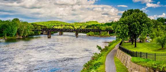 a bridge over a river with a path next to it