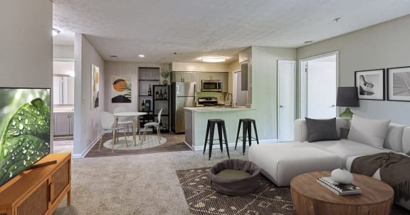 a living room and kitchen with a couch and a table