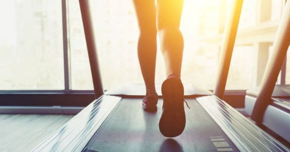 a person running on a treadmill with text get fit