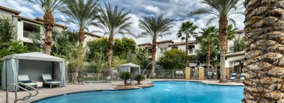 Pool with lounge seating and palm trees