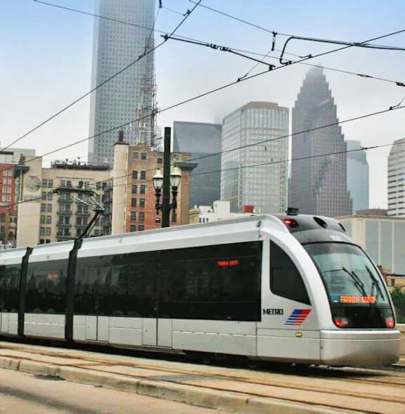 A train is on a track in a city.