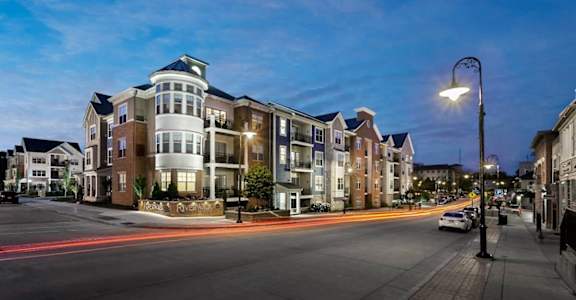 an apartment building on a city street at night