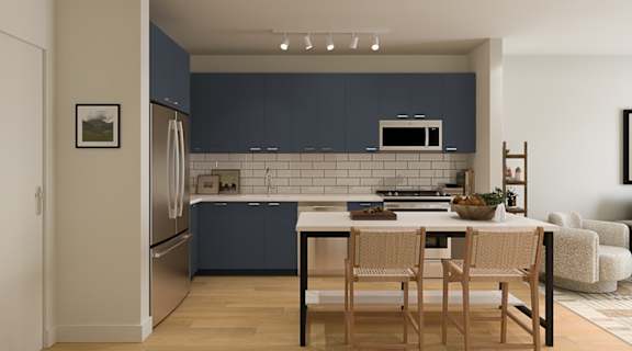A kitchen with a table and chairs.
