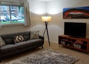 Thumbnail 11 of 19 - Scotsdale Lower Level Living Room 1 at Scotsdale Apartments, IA, 52241