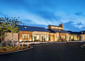 Thumbnail 1 of 25 - Inviting apartment community entrance with upscale architecture, professional landscaping, and a well-lit arrival experience.