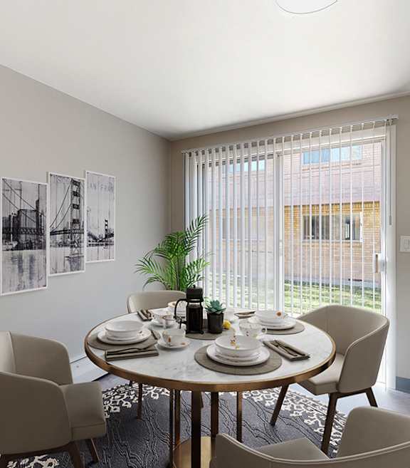 A dining room with a table set for four and a plant on the windowsill.
