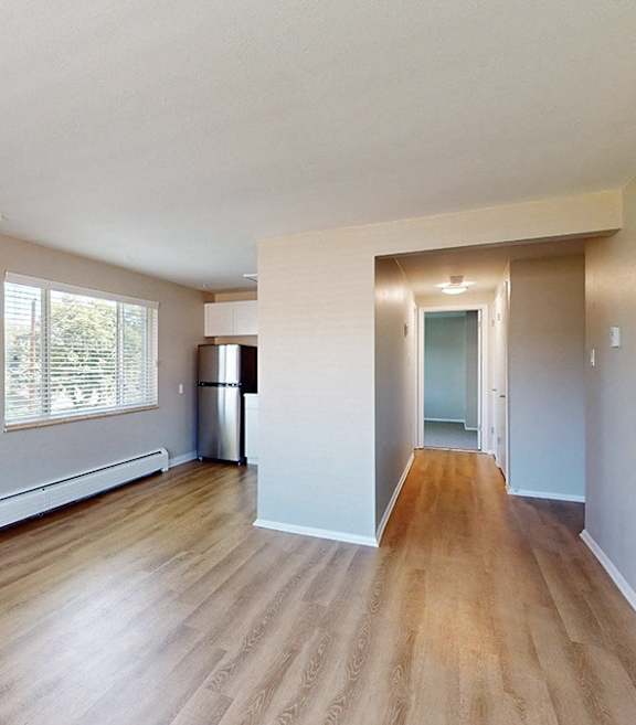 A room with wooden floors and white walls.
