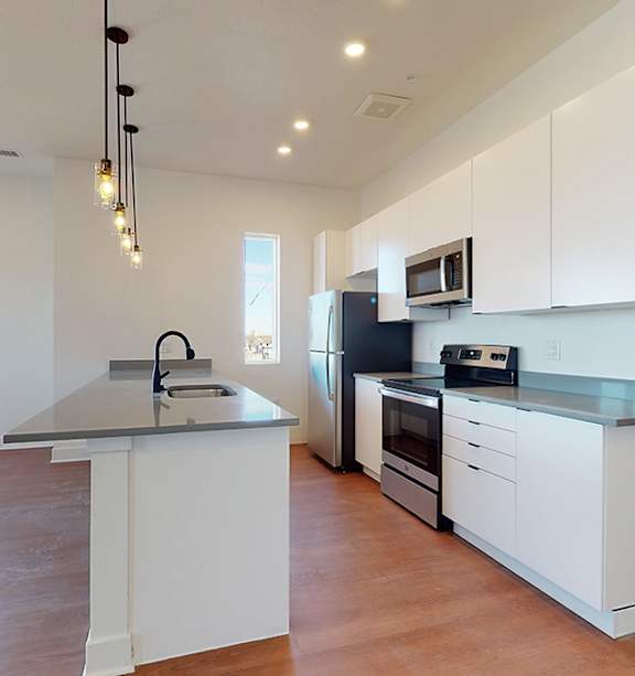 Kitchen with White Cabinets at Mile Apartments, Denver, Colorado