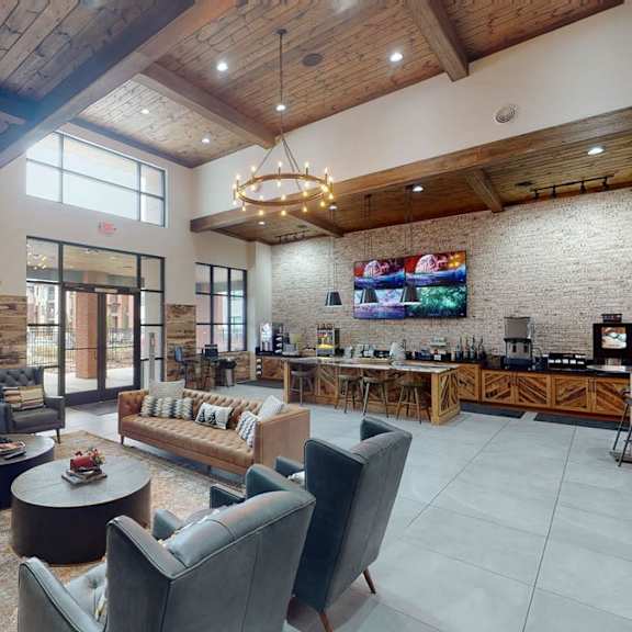 A coffee bar with a counter and a table with chairs in the lounge at 49 West. 