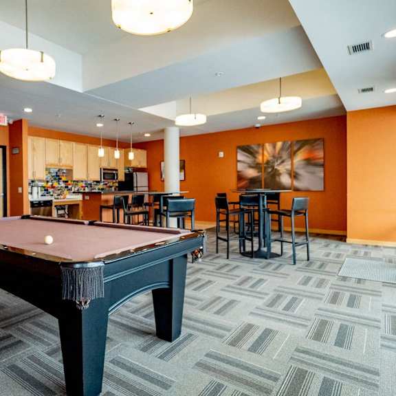 a game room with a pool table and a bar