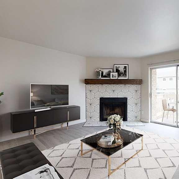 A living room with a fireplace and a television.