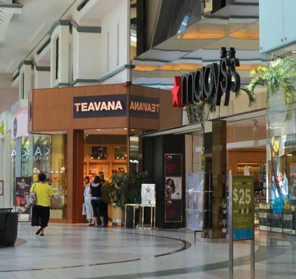 the shopping mall is full of shops and shoppers