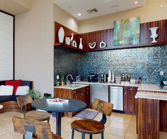 Resident lounge with a communal kitchen and seating at Acclaim. 