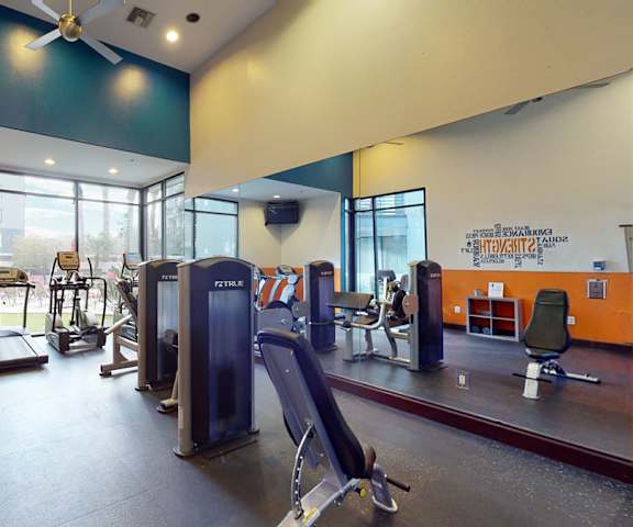 A gym with cardio and weight machine at Acclaim. 