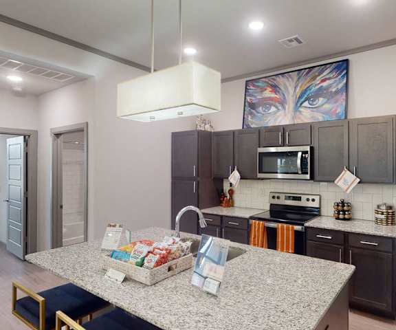 A kitchen with stainless steel appliances and granite counter tops at 49 West. 