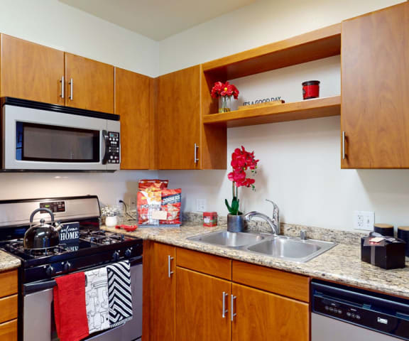 a kitchen with wood cabinets and granite countertops
