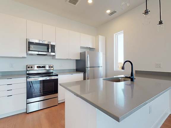 Kitchen with Microwave at Mile Apartments, Denver, CO
