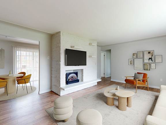 A living room with a fireplace and a television.