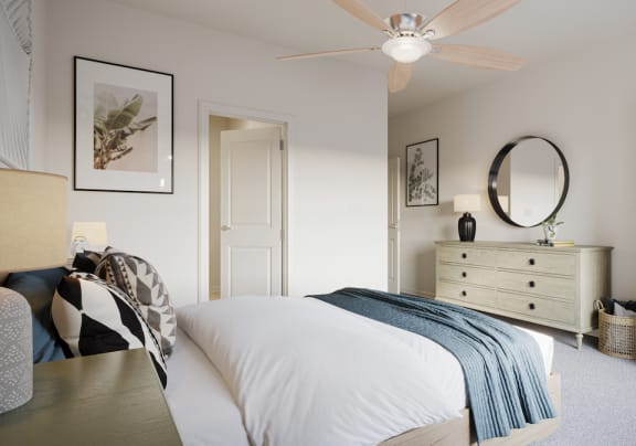 a bedroom with a bed and a dresser and a ceiling fan