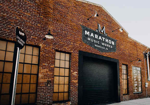 A brick building with a sign that says Marathon Music Works.