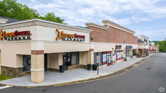 the exterior of a grocery store with a sidewalk in front of it
