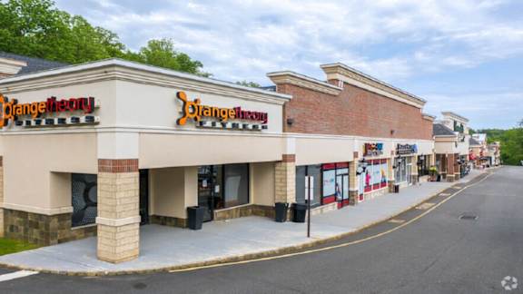 the exterior of a grocery store with a sidewalk in front of it