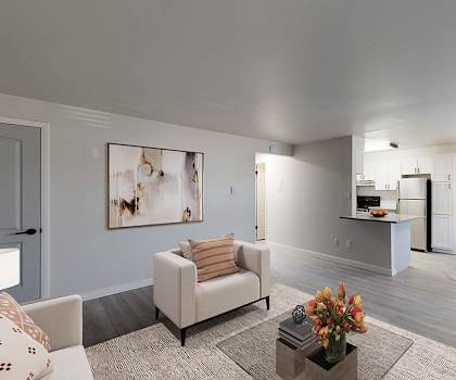 A living room with a grey couch and a coffee table.