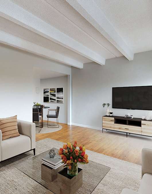 A living room with a sofa, armchair, and a coffee table.