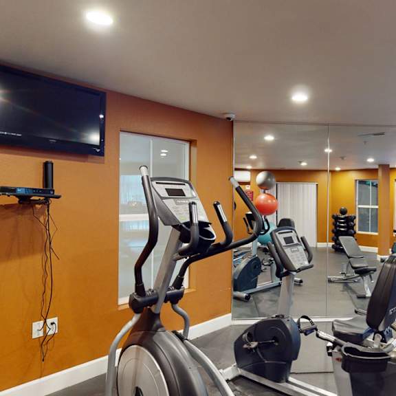 Citifront Apartments fitness room with workout equipment 