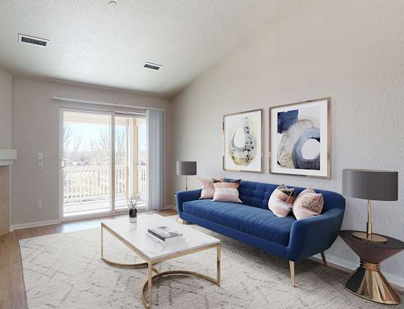 A living room with a blue couch and a fireplace.