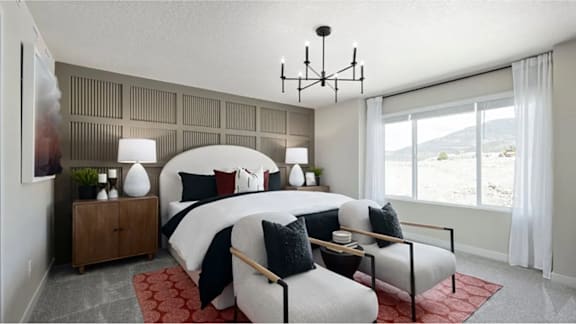 A bedroom with a large bed and a view of the outdoors through a window.