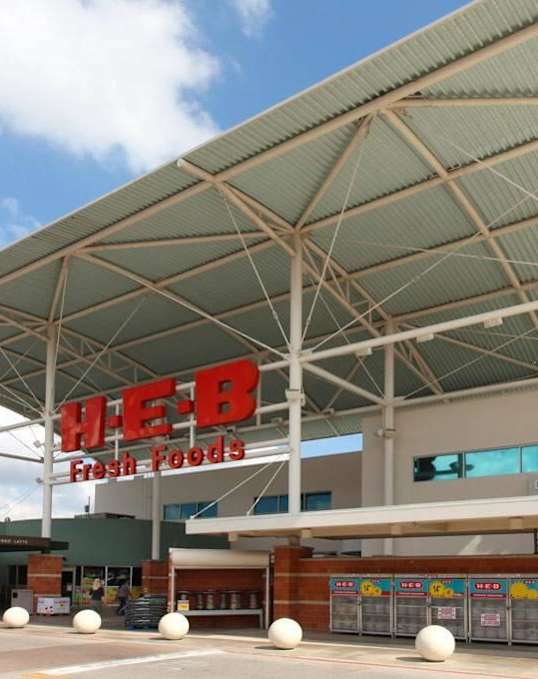 A street view of Legal Cinemas 16 with a clear sky above.