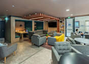 Thumbnail 8 of 8 - A modern lounge area with grey and yellow accent chairs.