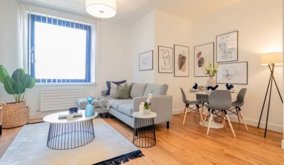 a living room with a couch and a dining room table at The Keel Apartments, Liverpool, L3 4GE
