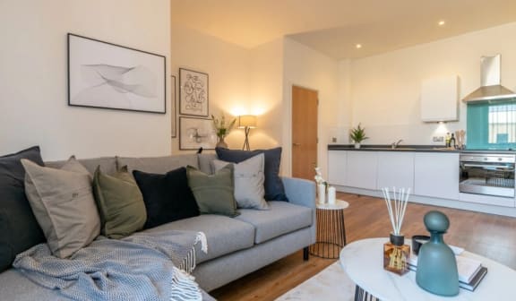 a living room with a couch and a table at The Keel Apartments, Liverpool, L3 4GE