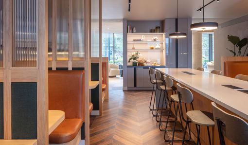 a kitchen and dining area with a long counter and stools