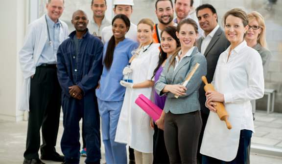 A group of people in medical attire stand together.