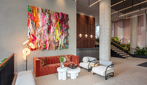 a living room with a colorful piece of art on the wall