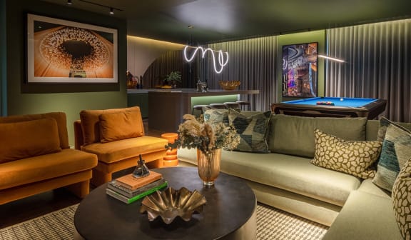 a living room with couches and a pool table