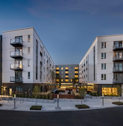 A modern apartment complex with balconies and multiple floors.