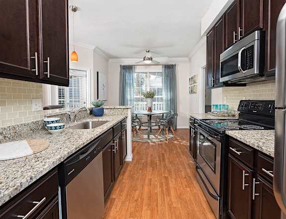 a kitchen with granite counter tops and stainless steel appliances