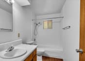 Thumbnail 3 of 9 - a bathroom with a sink and a toilet and a shower