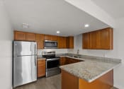 Thumbnail 2 of 11 - a kitchen with stainless steel appliances and granite counter tops
