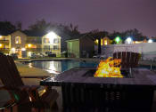 Thumbnail 22 of 22 - Night time image of fire pit located next to the pool
