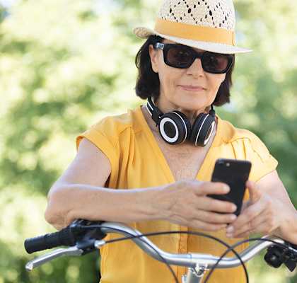 Woman looking at phone on bike at Heron Pointe, Miramar
